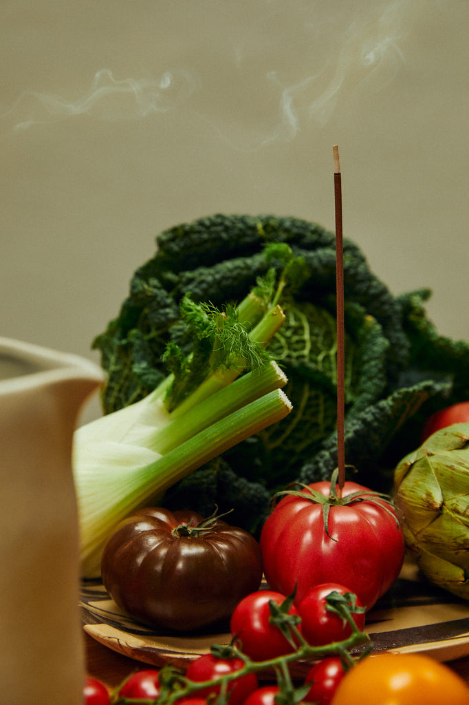 Incense Stick surrounded by fruits and vegetables