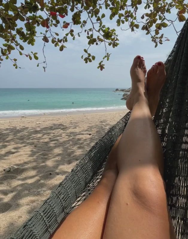 woman on a swing by the beach