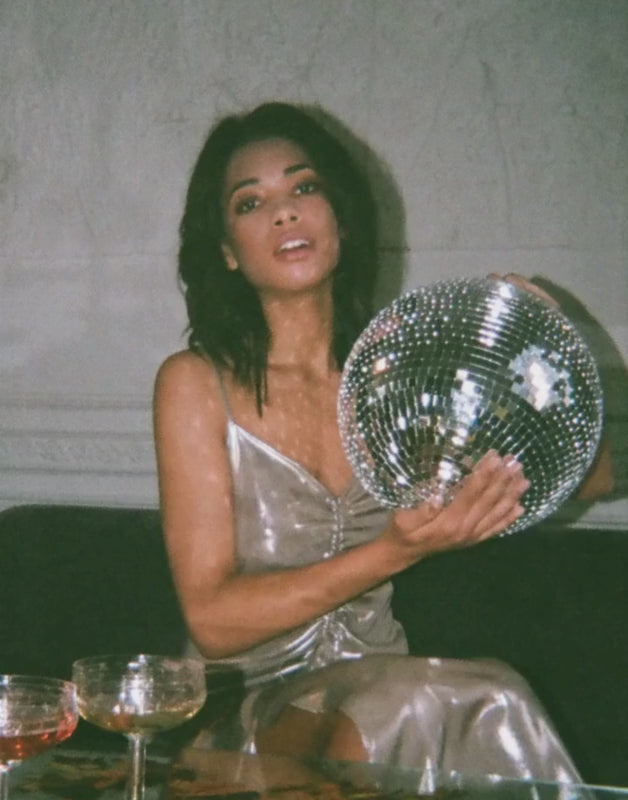 woman holding a disco ball