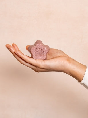 Hand Holding a Wild Flowers Solid Shampoo Bar