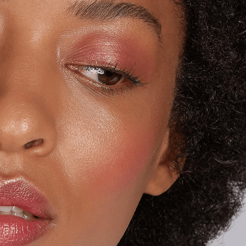 woman with dark skin tone wearing Raspberry Lip-to-Lid Balmie