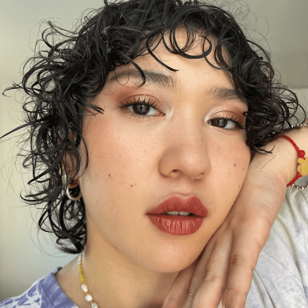 woman with light skin tone wearing Cinnamon Lip-to-Lid Balmie on lips and eyelids