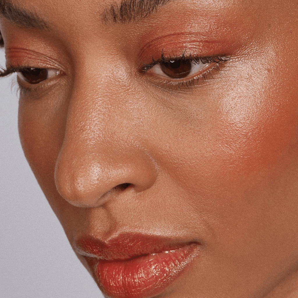 woman with dark skin tone wearing Strawberry Lip-to-Lid Balmie