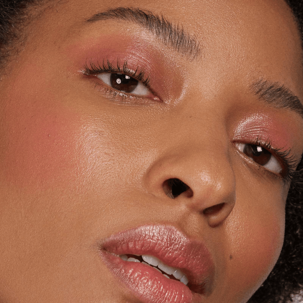 woman with dark skin tone wearing Peach Lip-to-Lid Balmie on lips and lids