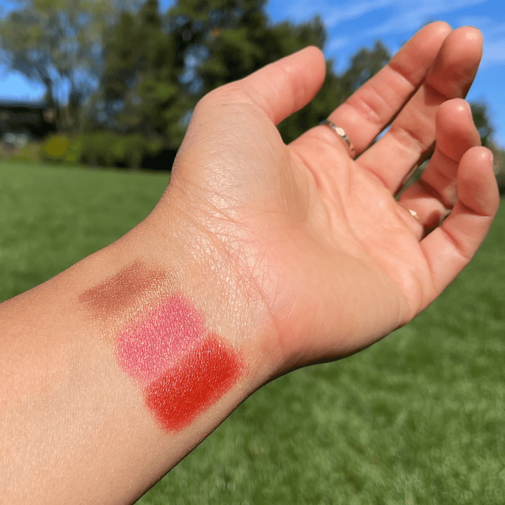 close-up of wrist with the color swatches from Golden Hour Lip-to-Lid Balmies