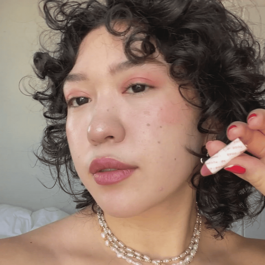 woman with light skin tone wearing Nude Plum + Rose Lip-to-Lid Balmie