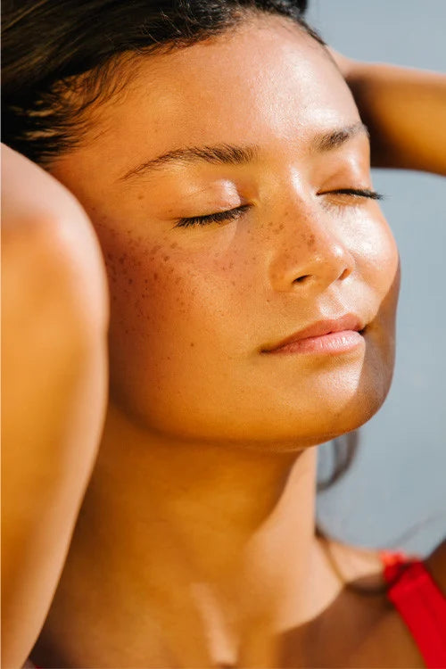 woman facing sun after applying Laboratoires de Biarritz tinted sunscreen