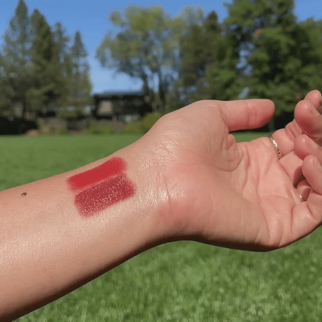 wrist showing color swatches from Cherry + Strawberry Lip-to-Lid Balmie