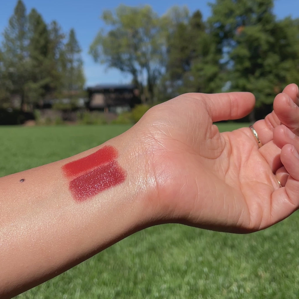 color swatches of Cherry + Strawberry Lip-to-Lid Balmie on wrist