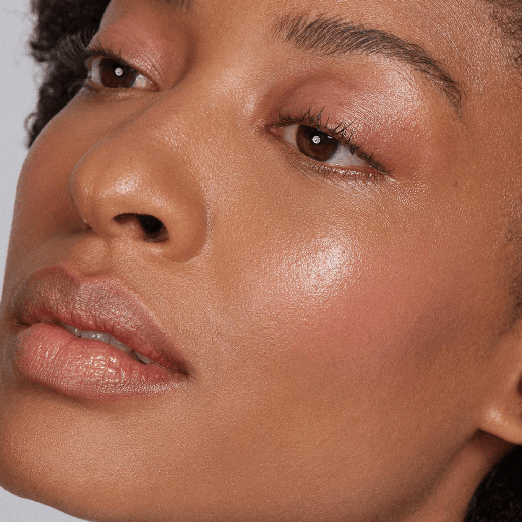 woman with dark skin tone wearing Clementine Lip-to-Lid Balmie