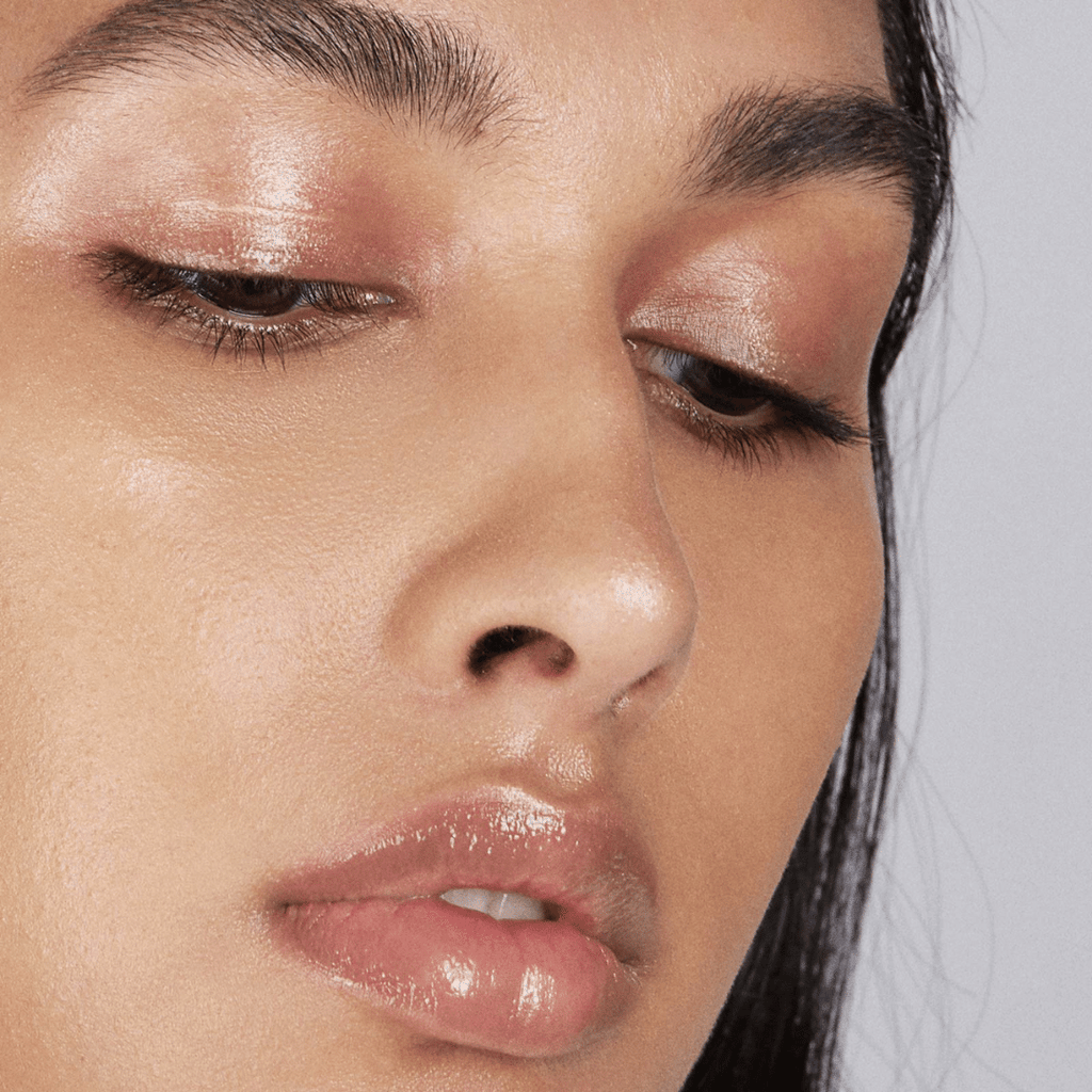 close up of face of woman with medium skin tone wearing Caramel Lip-to-Lid Balmie