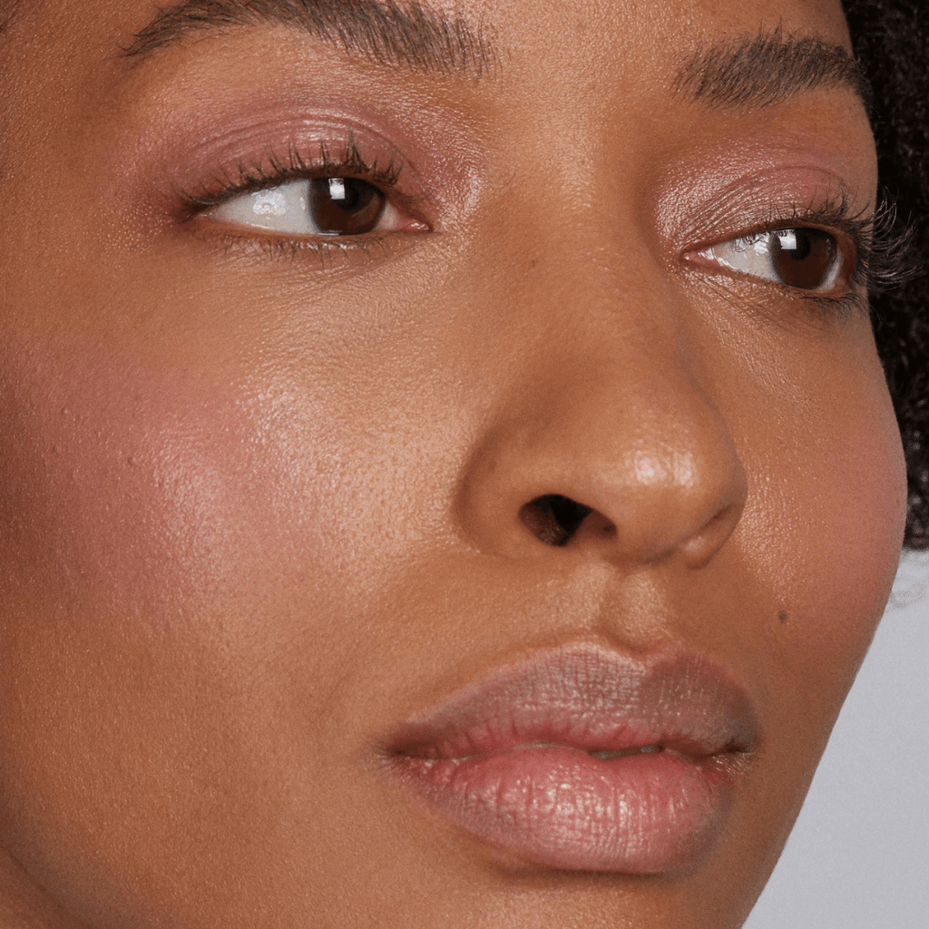 woman with dark skin tone wearing one of the Cotton Candy Skies Lip-to-Lid Balmies