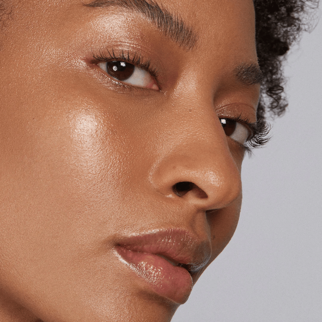 woman with dark skin tone wearing Golden Hour Lip-to-Lid Balmies on eyelids and lips