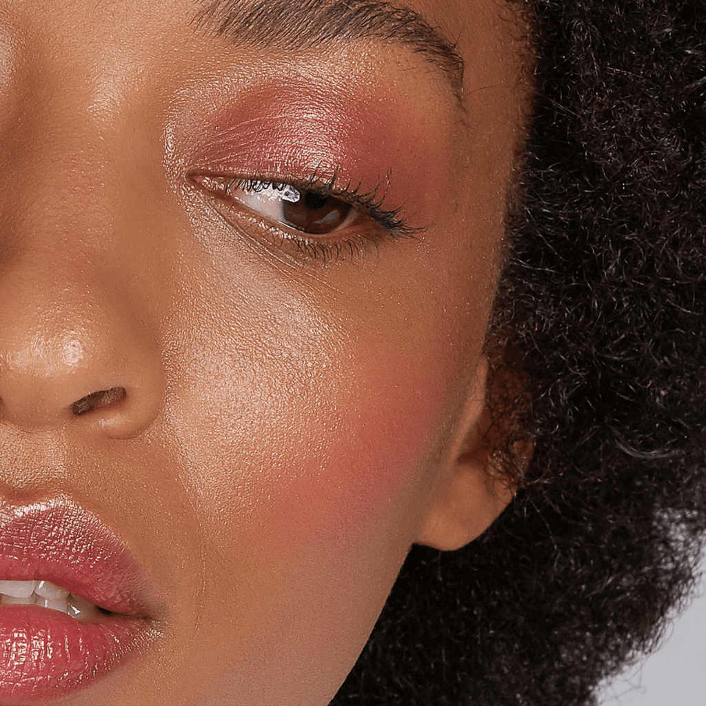 closeup of woman with dark skin tone wearing Out of Office Lip-to-Lid Balmies on eyelids and lips