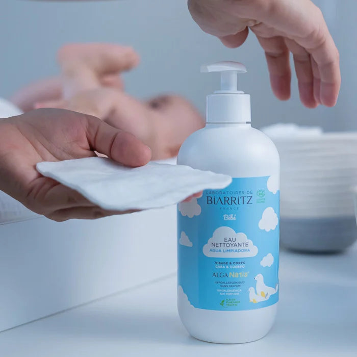 hand dispensing cleansing water on a wipe