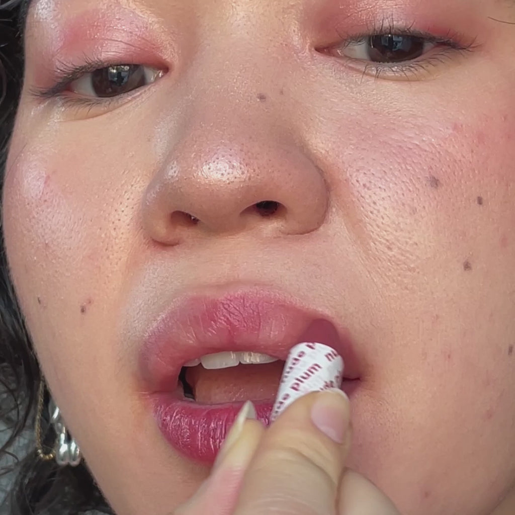 woman with light skin tone applying one of the Of the Earth Lip-to-Lid Balmies